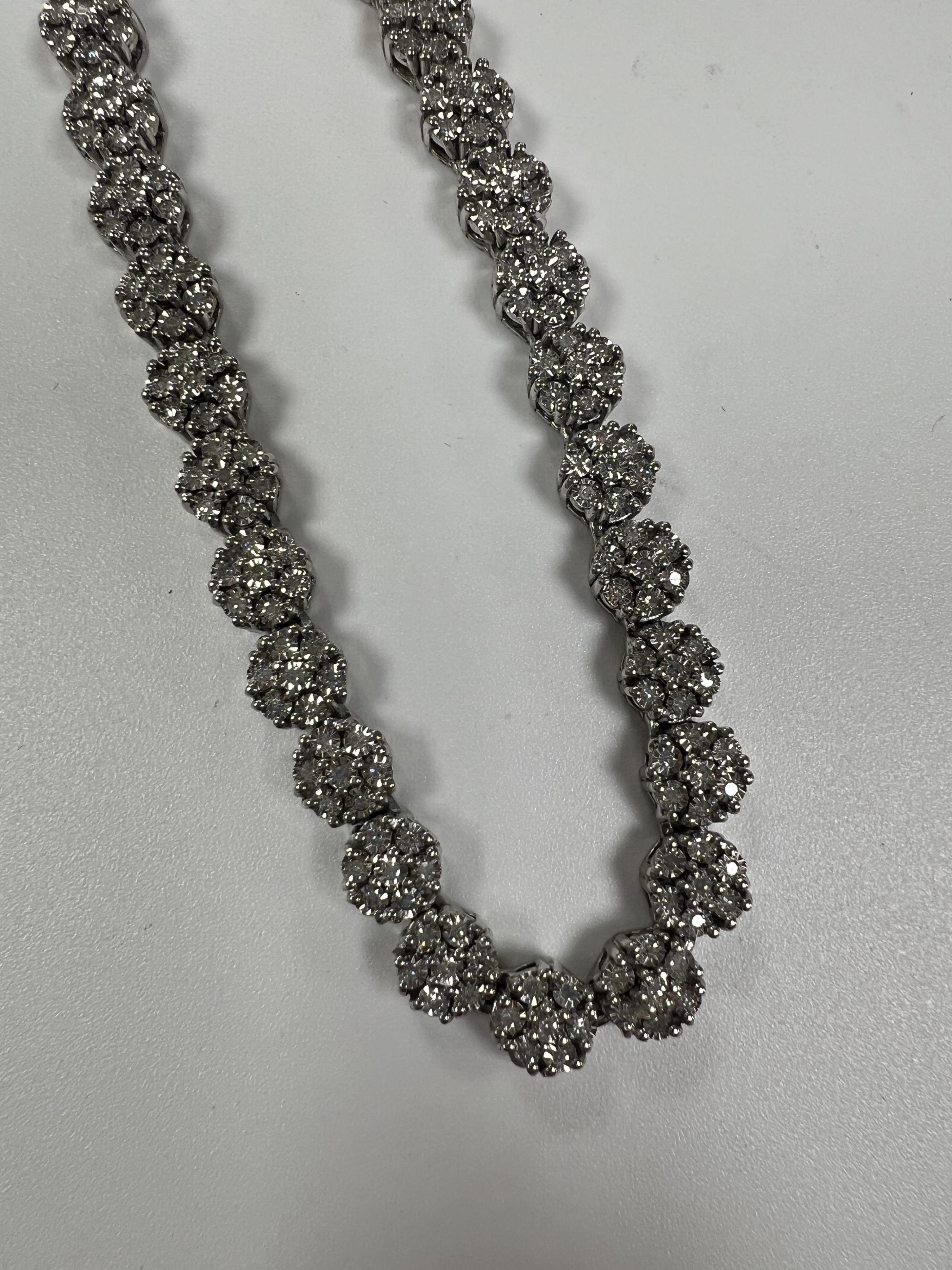 A modern Indian 925 and diamond chip set flower head cluster line necklace, 44cm, in original TJC box.